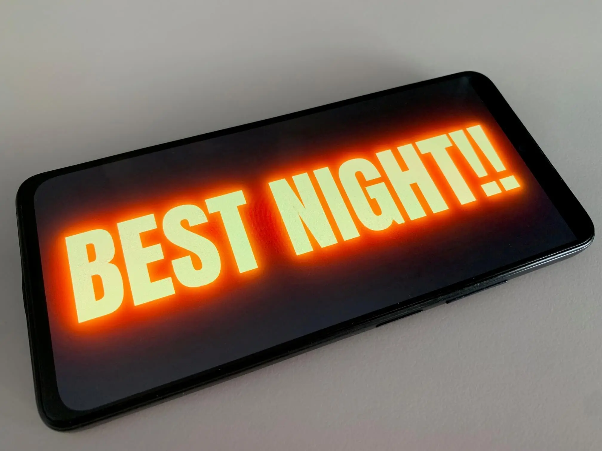 Phone showing a supportive concert sign with the message Best Night of My Life